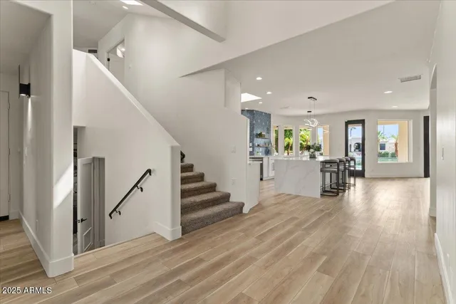 a view of a living room kitchen and a wooden floor