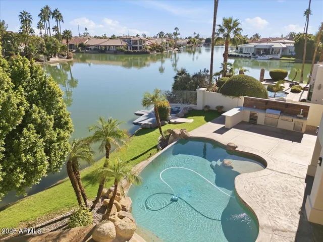 a view of a lake with a house and a garden