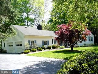 33 Quaker Road West Windsor, NJ 08550 - Photo 1 of 6 a front view of a house with garden and trees