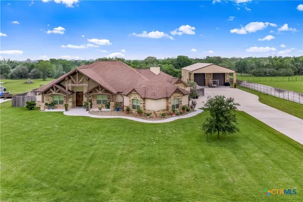 a aerial view of a house with swimming pool garden and patio