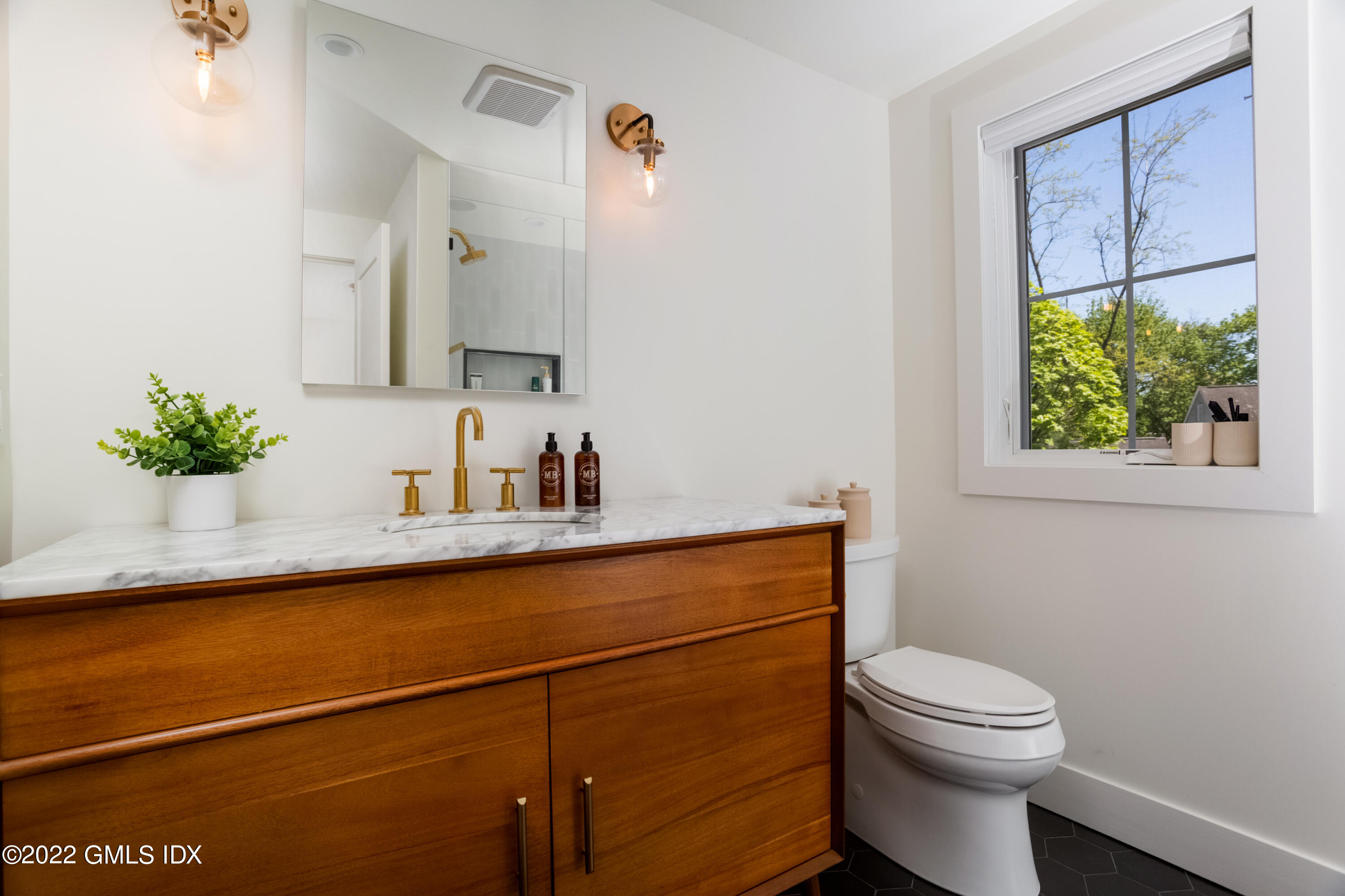 6 Chapel Lane Riverside, CT 06878 - Photo 16 of 29 a bathroom with a sink a mirror and a toilet