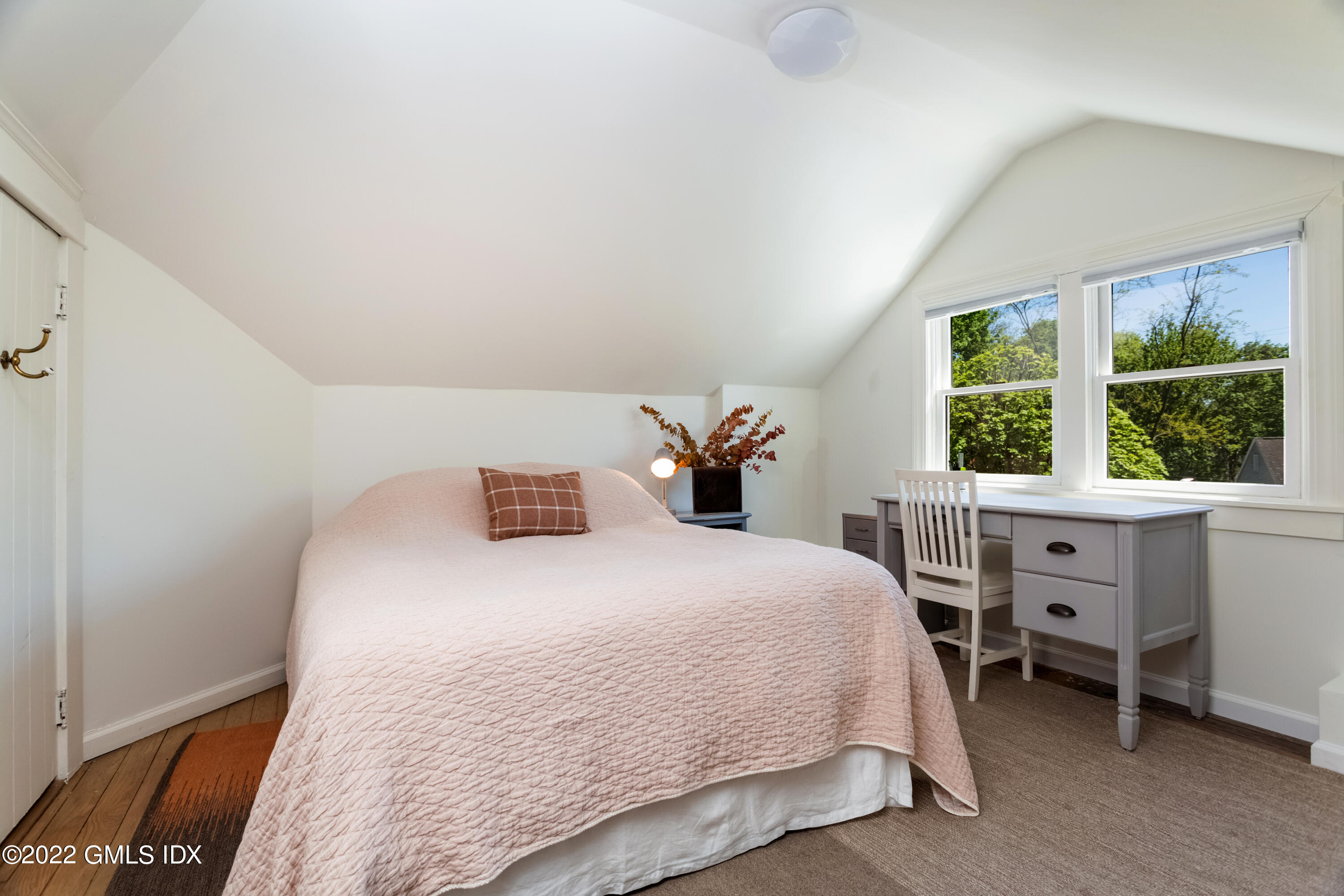 6 Chapel Lane Riverside, CT 06878 - Photo 19 of 29 a bedroom with a bed a table and windows