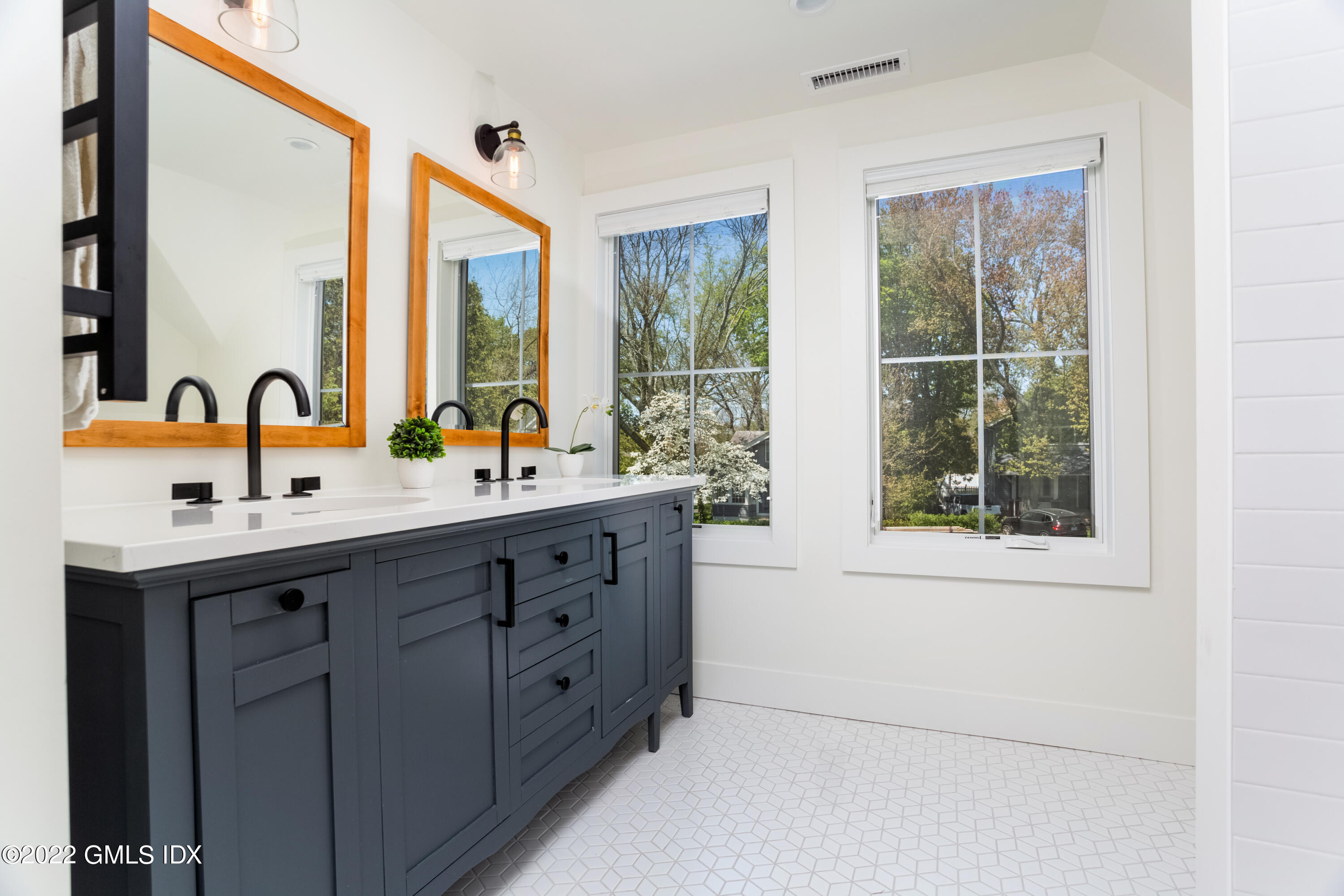 6 Chapel Lane Riverside, CT 06878 - Photo 20 of 29 a bathroom with a double vanity sink and a large mirror