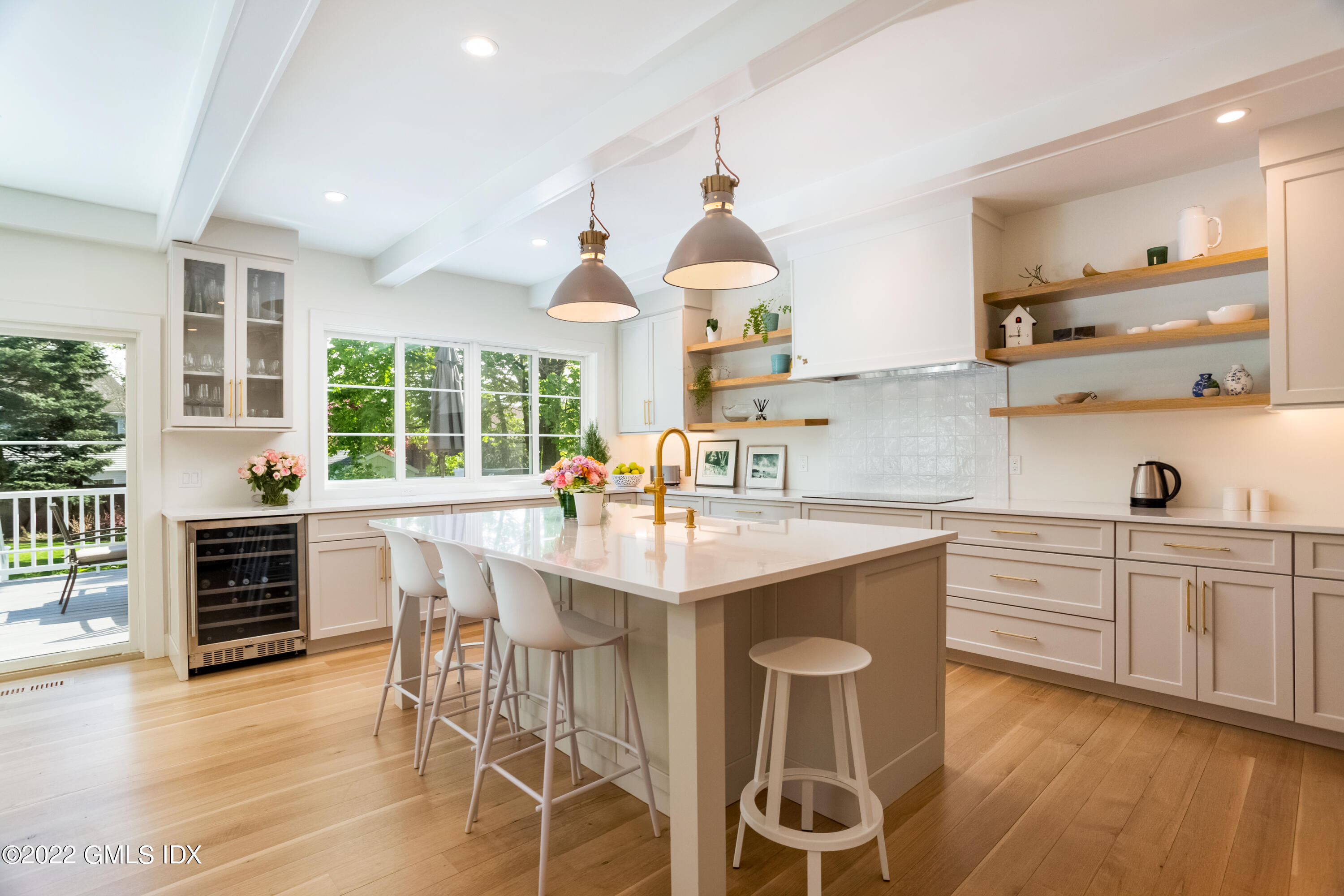 6 Chapel Lane Riverside, CT 06878 - Photo 7 of 29 a kitchen with stainless steel appliances a table and chairs in it