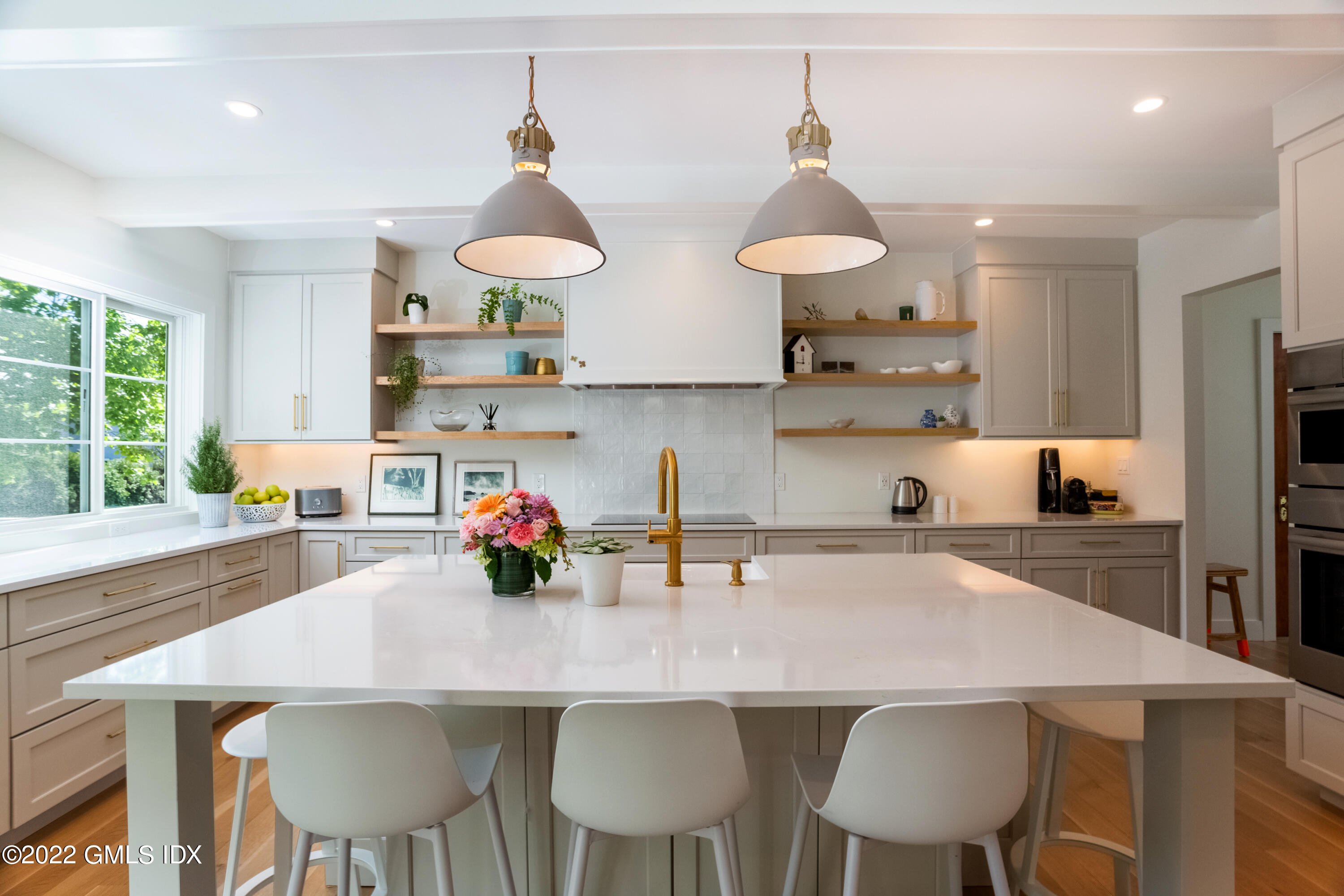 6 Chapel Lane Riverside, CT 06878 - Photo 8 of 29 a kitchen with stainless steel appliances a dining table and chairs