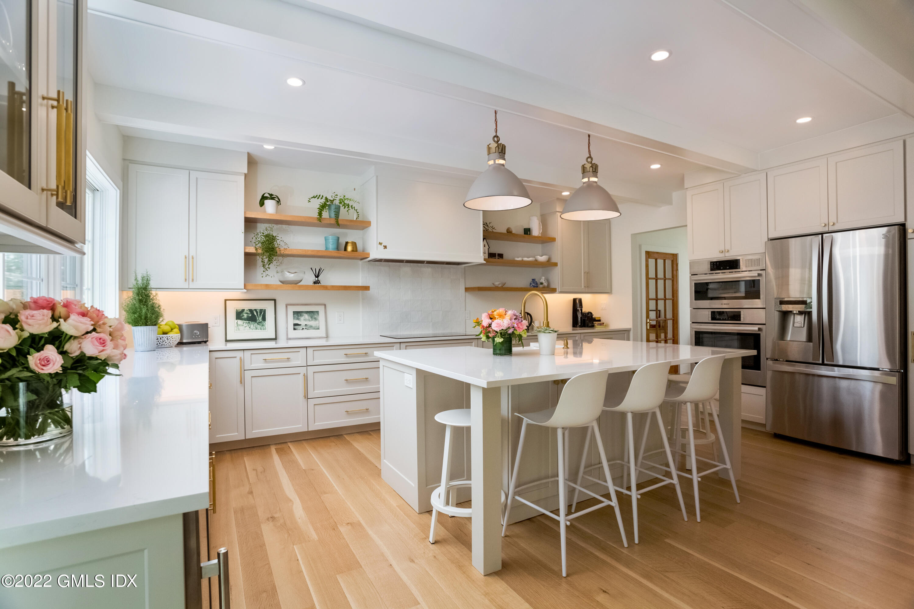 6 Chapel Lane Riverside, CT 06878 - Photo 10 of 29 a kitchen with white cabinets and stainless steel appliances