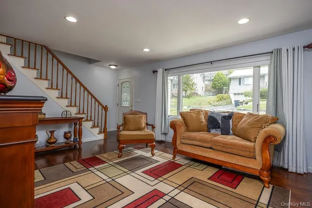 a living room with furniture a rug and a large window