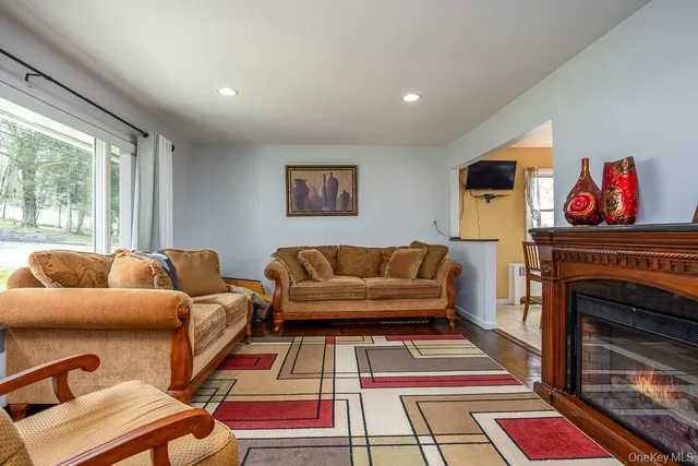 a living room with furniture fireplace and window