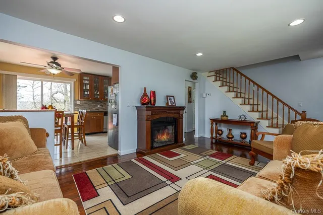 a living room with furniture a fireplace and a flat screen tv