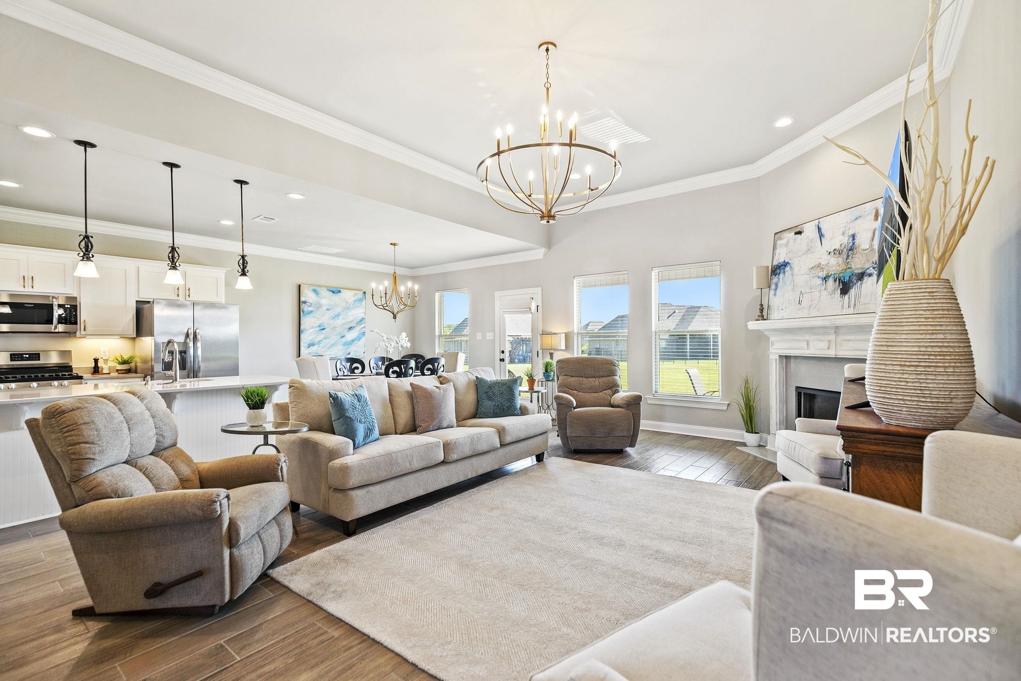 10140 Chipper Lane Foley, AL 36535 - Photo 11 of 72 Living room featuring light hardwood / wood-style flooring, crown molding, and an inviting chandelier