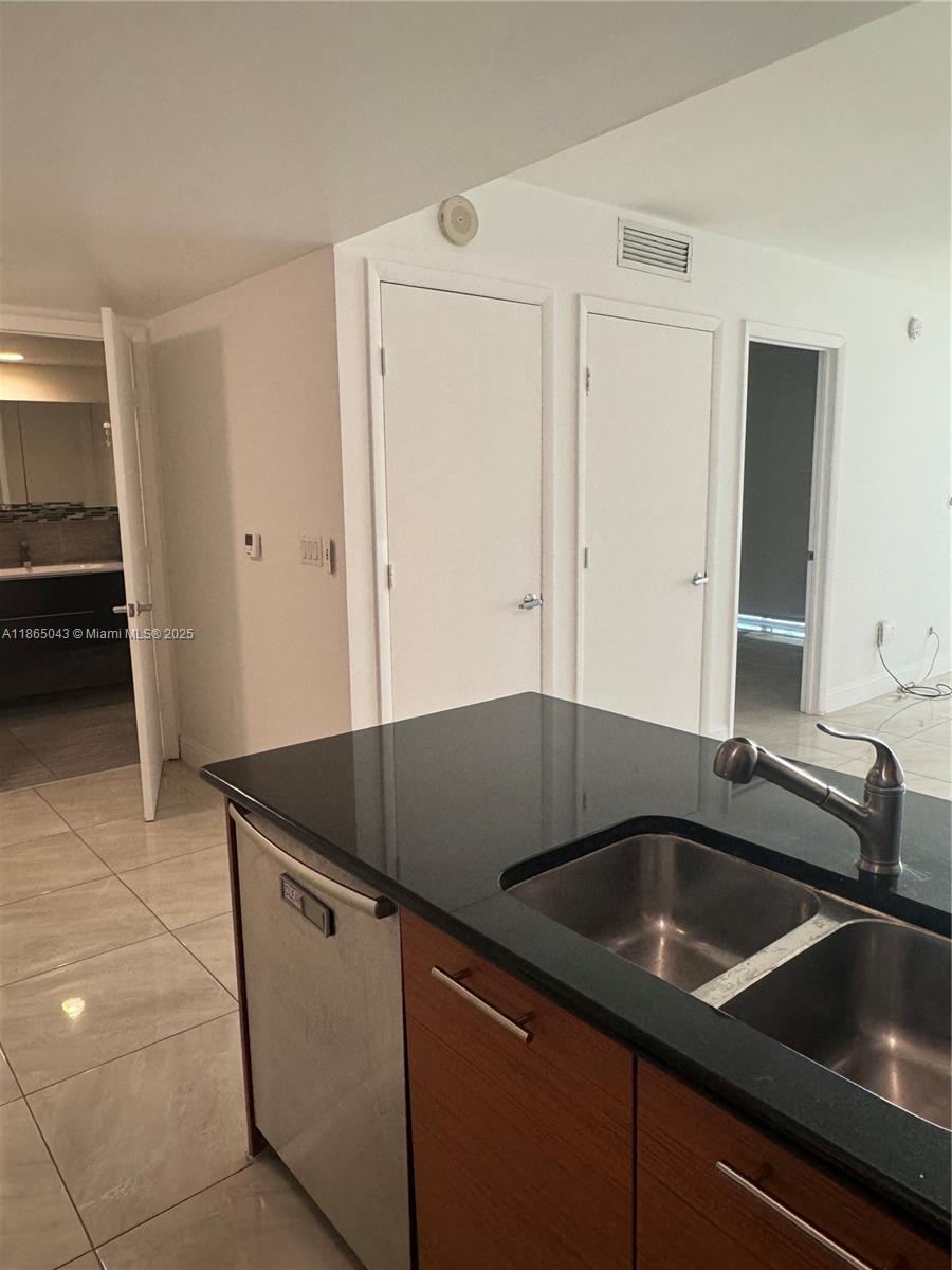 50 Biscayne Boulevard, Unit 3405 Miami, FL 33132 - Photo 12 of 40 a kitchen that has a sink and a stove