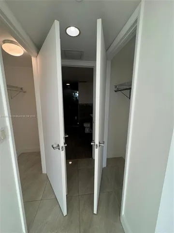 a view of a utility room with wooden floor