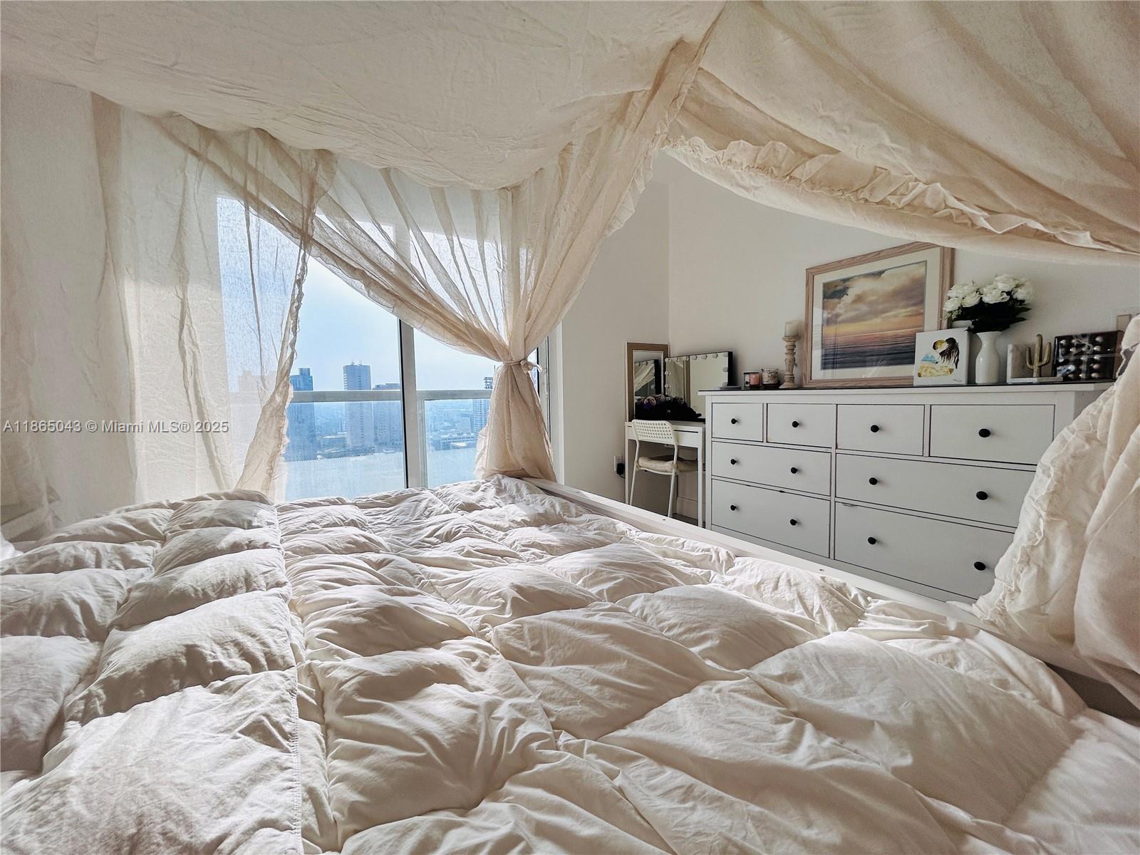 50 Biscayne Boulevard, Unit 3405 Miami, FL 33132 - Photo 17 of 40 a bedroom with a large bed and a window