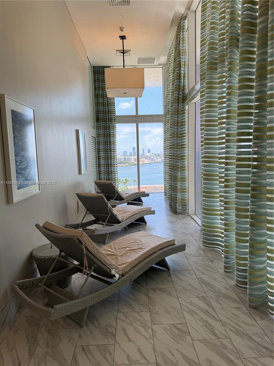 50 Biscayne Boulevard, Unit 3405 Miami, FL 33132 - Photo 23 of 40 a living room with furniture and a window