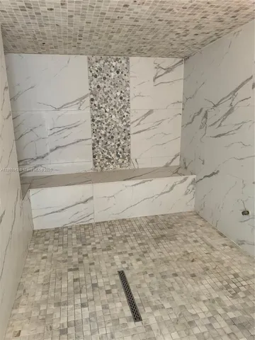 a room with gym equipment and kitchen view