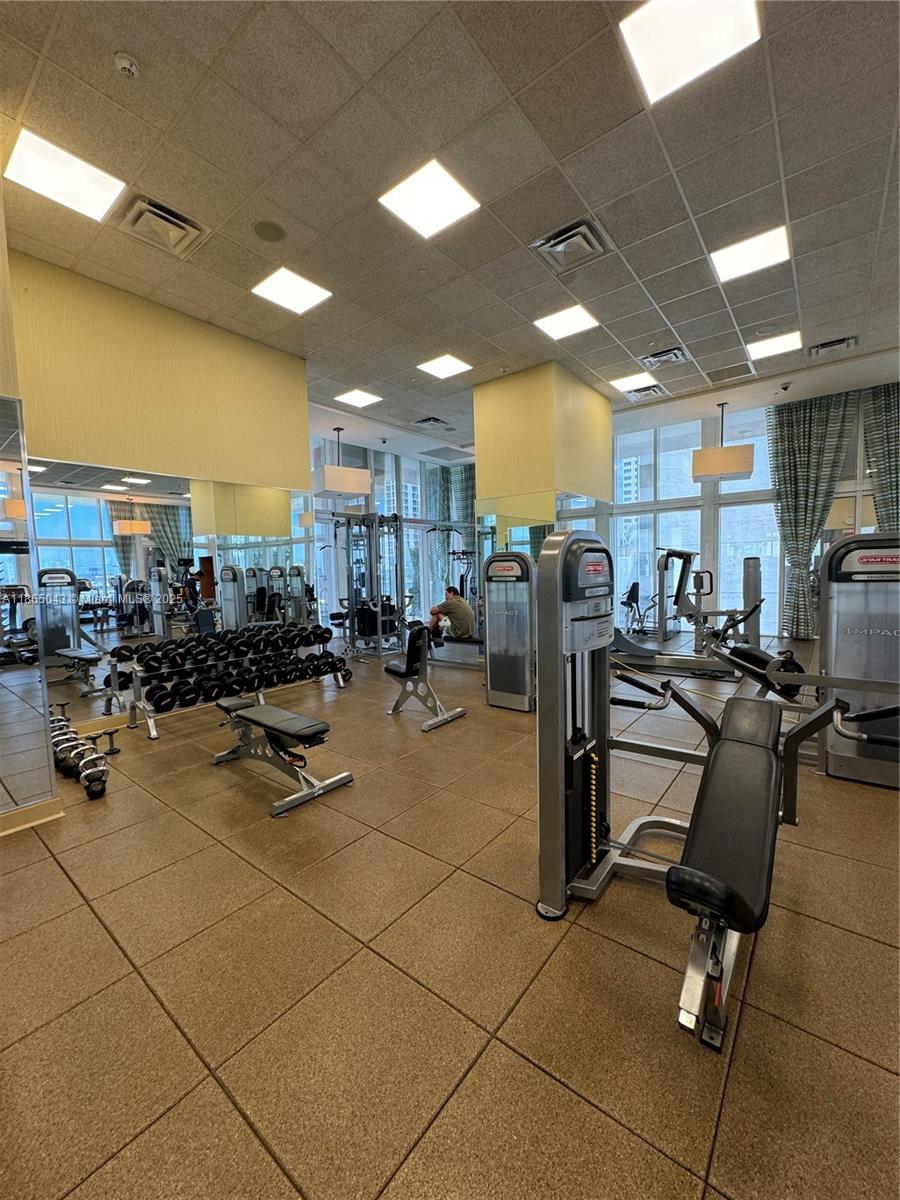 50 Biscayne Boulevard, Unit 3405 Miami, FL 33132 - Photo 28 of 40 a room with gym equipment and kitchen view