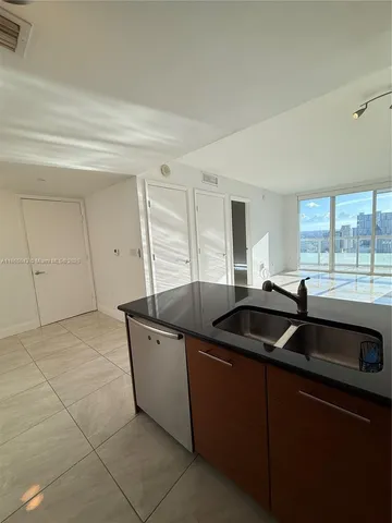 a kitchen that has a sink and cabinets