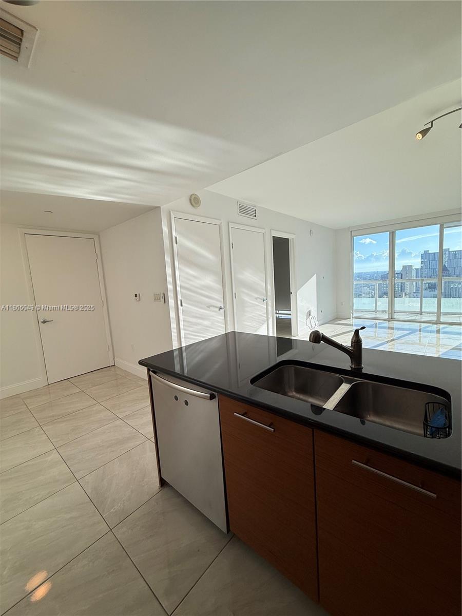 50 Biscayne Boulevard, Unit 3405 Miami, FL 33132 - Photo 5 of 40 a kitchen that has a sink and cabinets