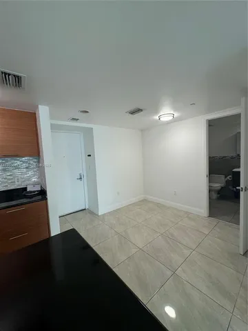 a kitchen with granite countertop a stove and a refrigerator