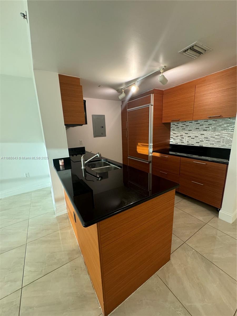 50 Biscayne Boulevard, Unit 3405 Miami, FL 33132 - Photo 9 of 40 a kitchen with granite countertop a stove and a refrigerator
