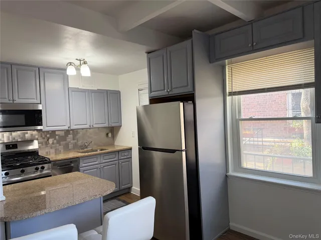 a kitchen with a refrigerator a sink and a stove top oven