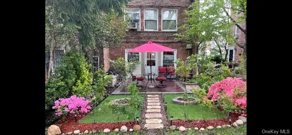 a view of a patio with chairs and flower plants