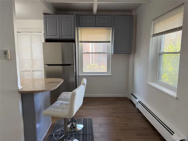 a view of a kitchen with a window and wooden floor
