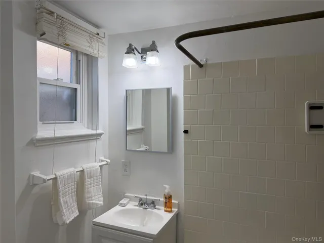 a bathroom with a sink mirror and vanity