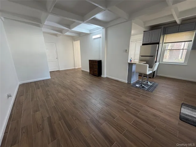 a view of a room with wooden floor and staircase