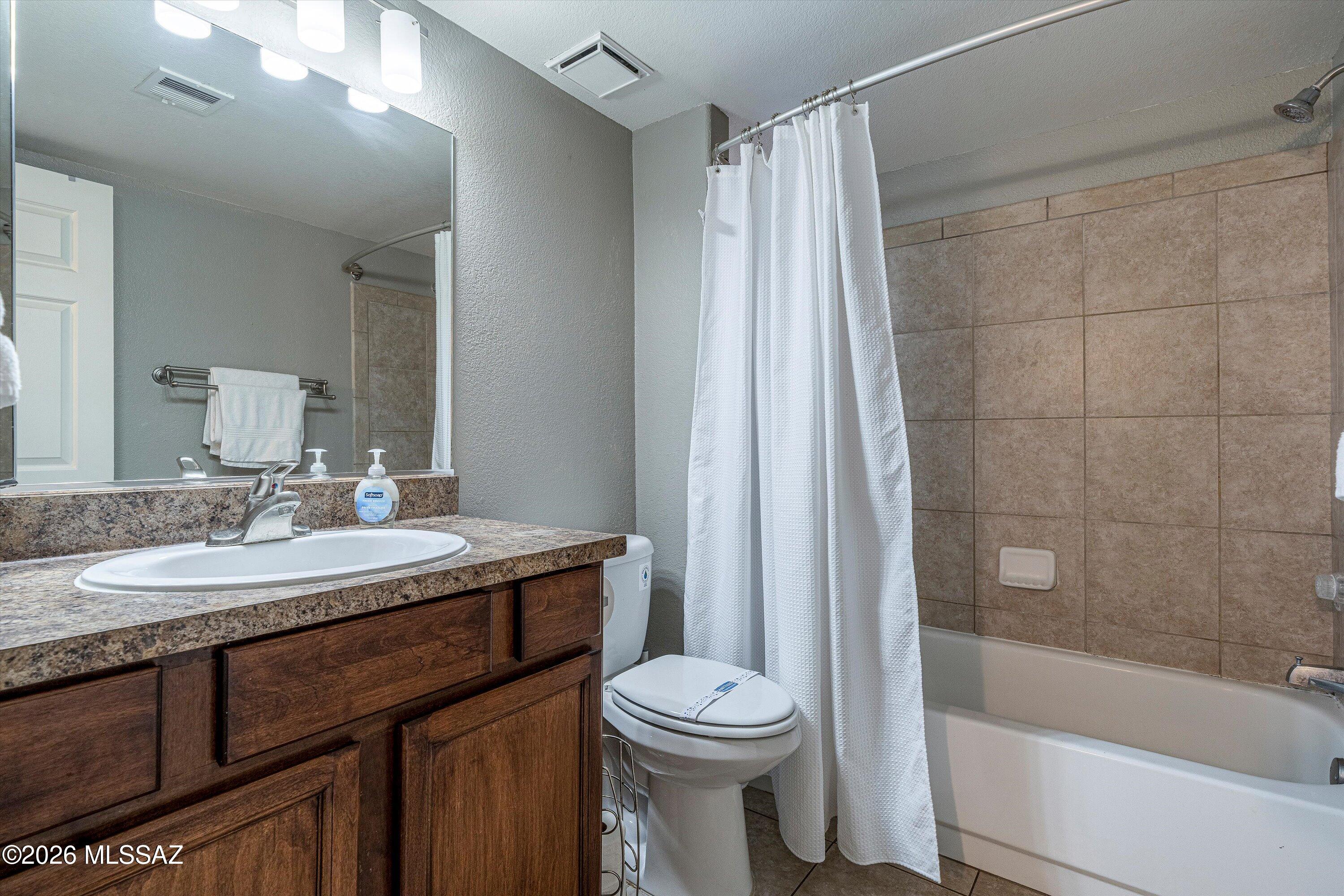 5855 North Kolb Road, Unit 8106 Tucson, AZ 85750 - Photo 14 of 34 a bathroom with a granite countertop sink toilet and shower