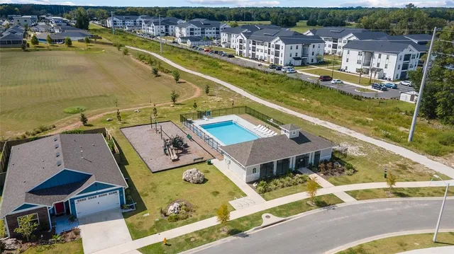 a view of a swimming pool with outdoor seating and lake view