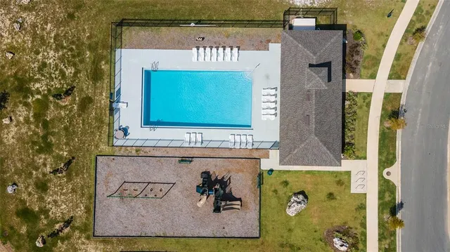 an aerial view of a house with a big yard