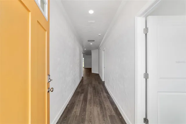 a view of a hallway with wooden floor
