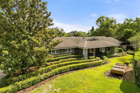 a view of a house with pool and chairs