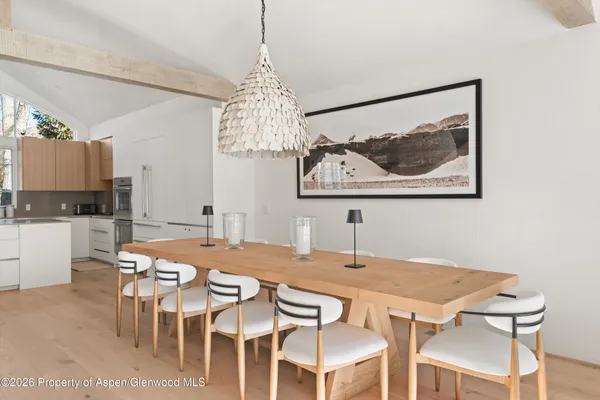 a view of a dining room with furniture and chandelier