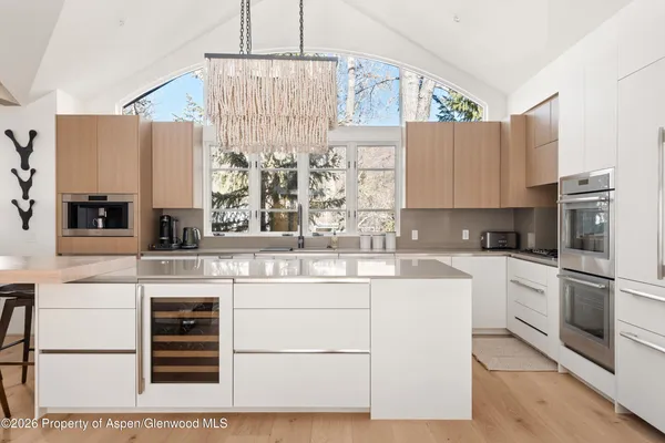 a kitchen with cabinets appliances and a center island