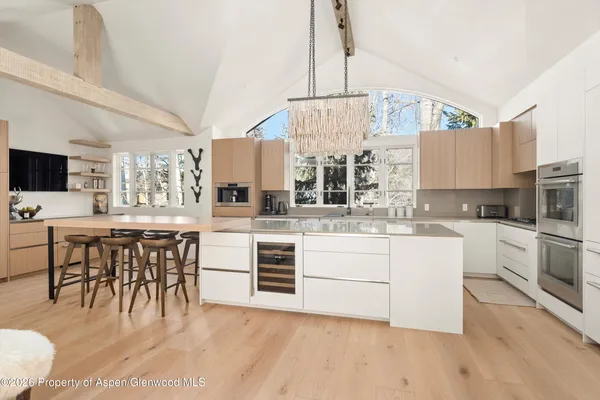 a kitchen with a white cabinets and chairs