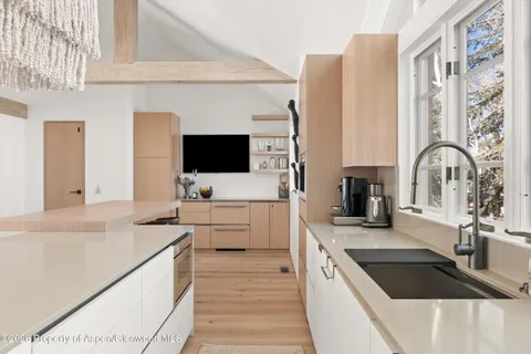 a kitchen with stainless steel appliances a sink a stove and a microwave