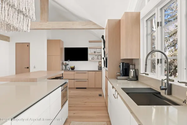 a kitchen with stainless steel appliances a sink a stove and a microwave