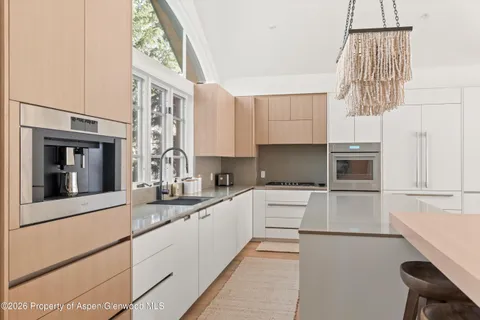 a kitchen with a sink cabinets and window