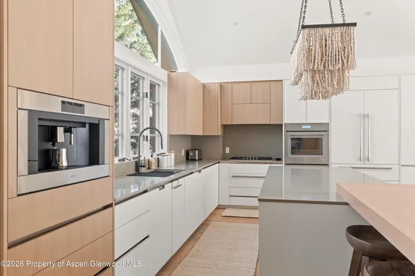a kitchen with a sink cabinets and window