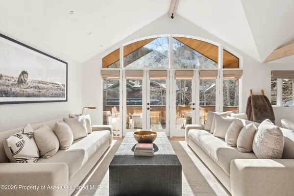 a living room with furniture and a large window