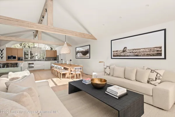a living room with furniture and a painting on the wall