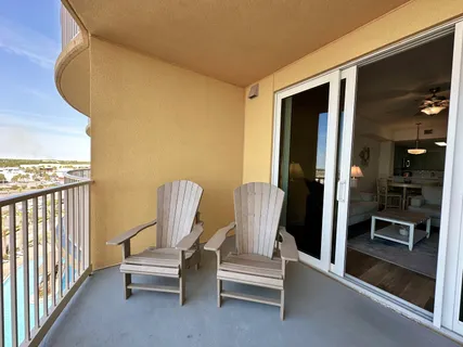 a view of a swimming pool with outdoor seating and deck