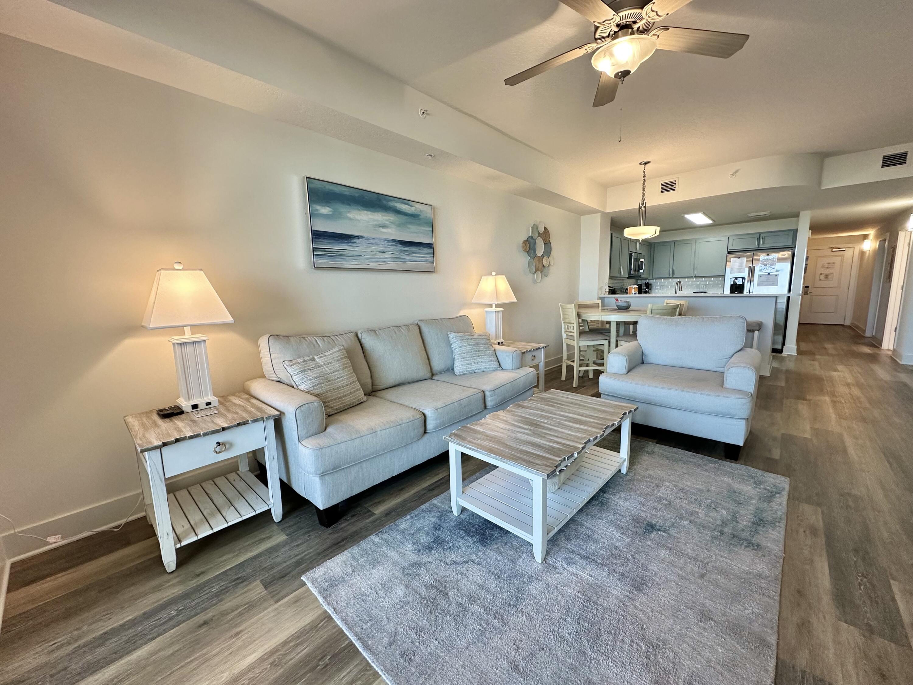 15928 Front Beach Road, Unit 3702 Panama City Beach, FL 32413 - Photo 23 of 85 a living room with furniture and a chandelier