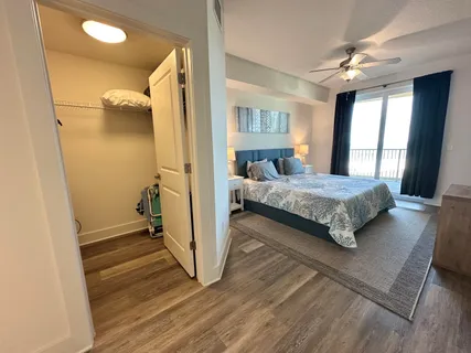 a bedroom with a bed and a flat tv screen on dresser