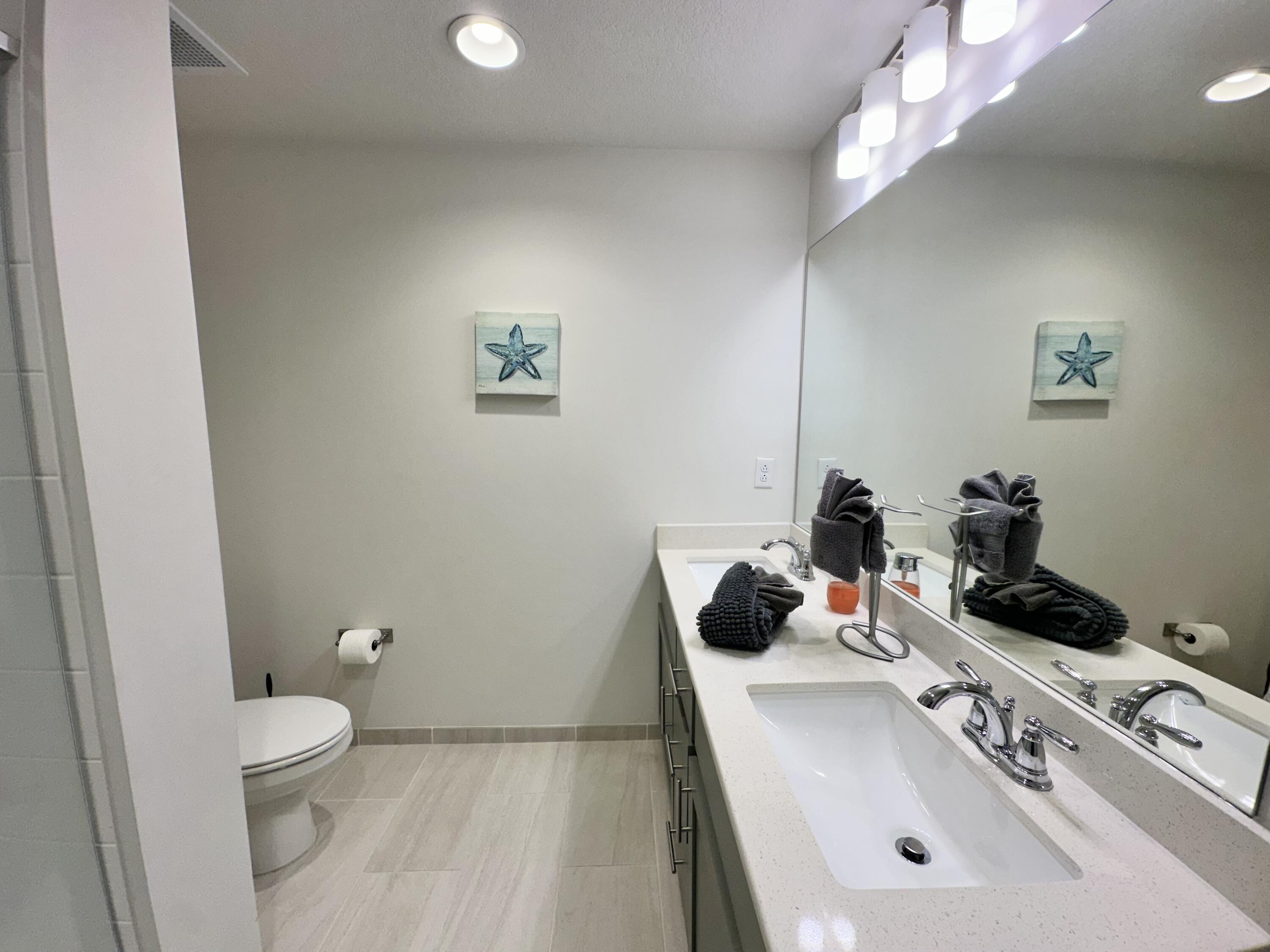 15928 Front Beach Road, Unit 3702 Panama City Beach, FL 32413 - Photo 31 of 85 a bathroom with a sink vanity granite and toilet