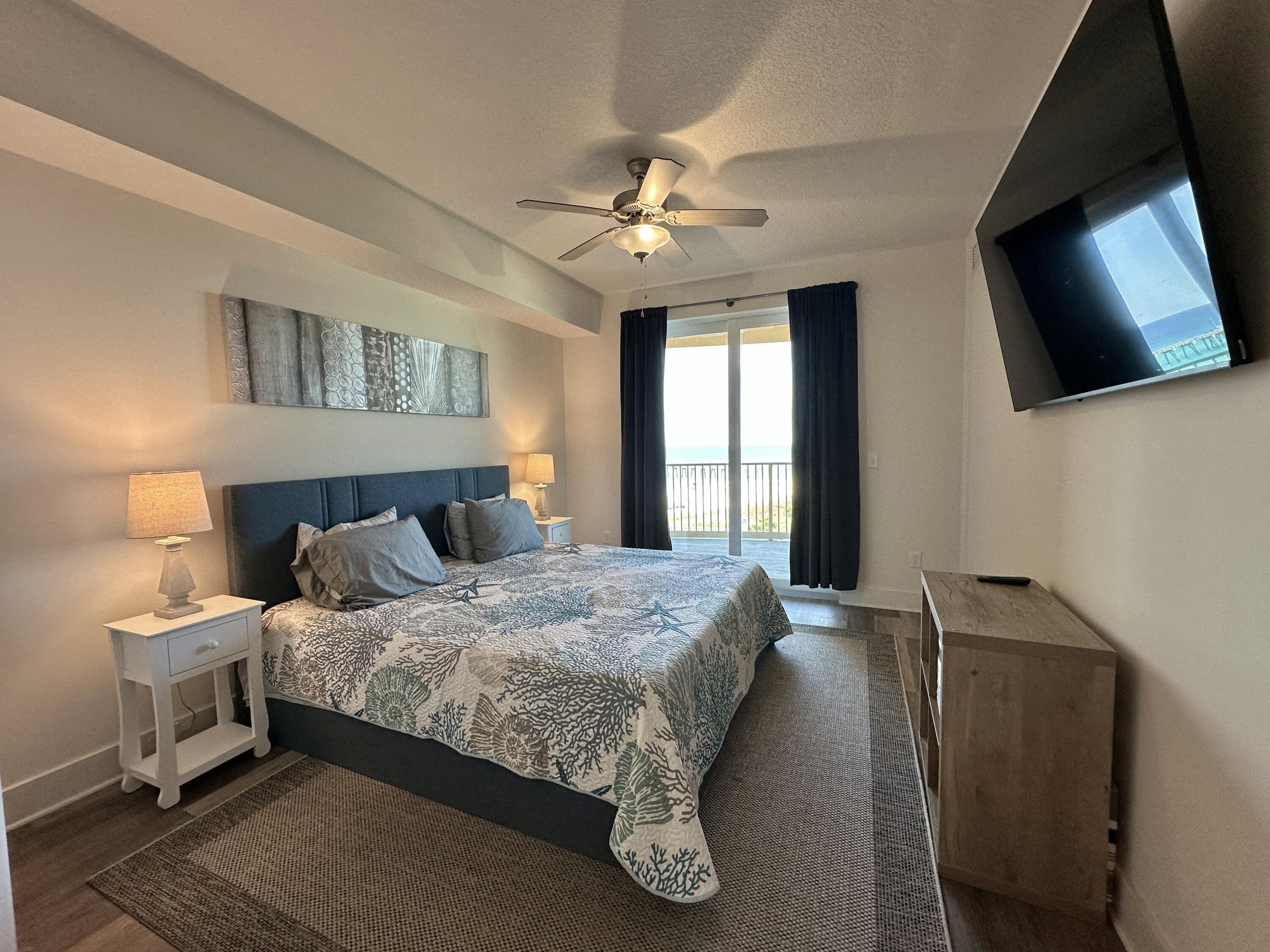 15928 Front Beach Road, Unit 3702 Panama City Beach, FL 32413 - Photo 33 of 85 a bedroom with a bed and a flat tv screen on dresser