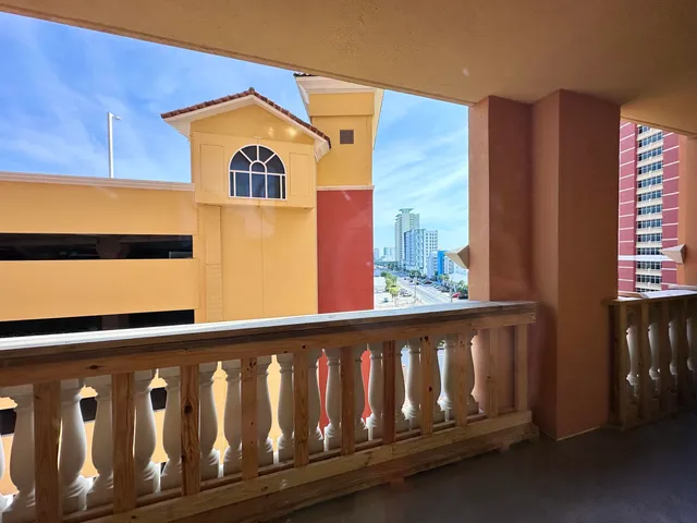 a view of a building with a tree in front