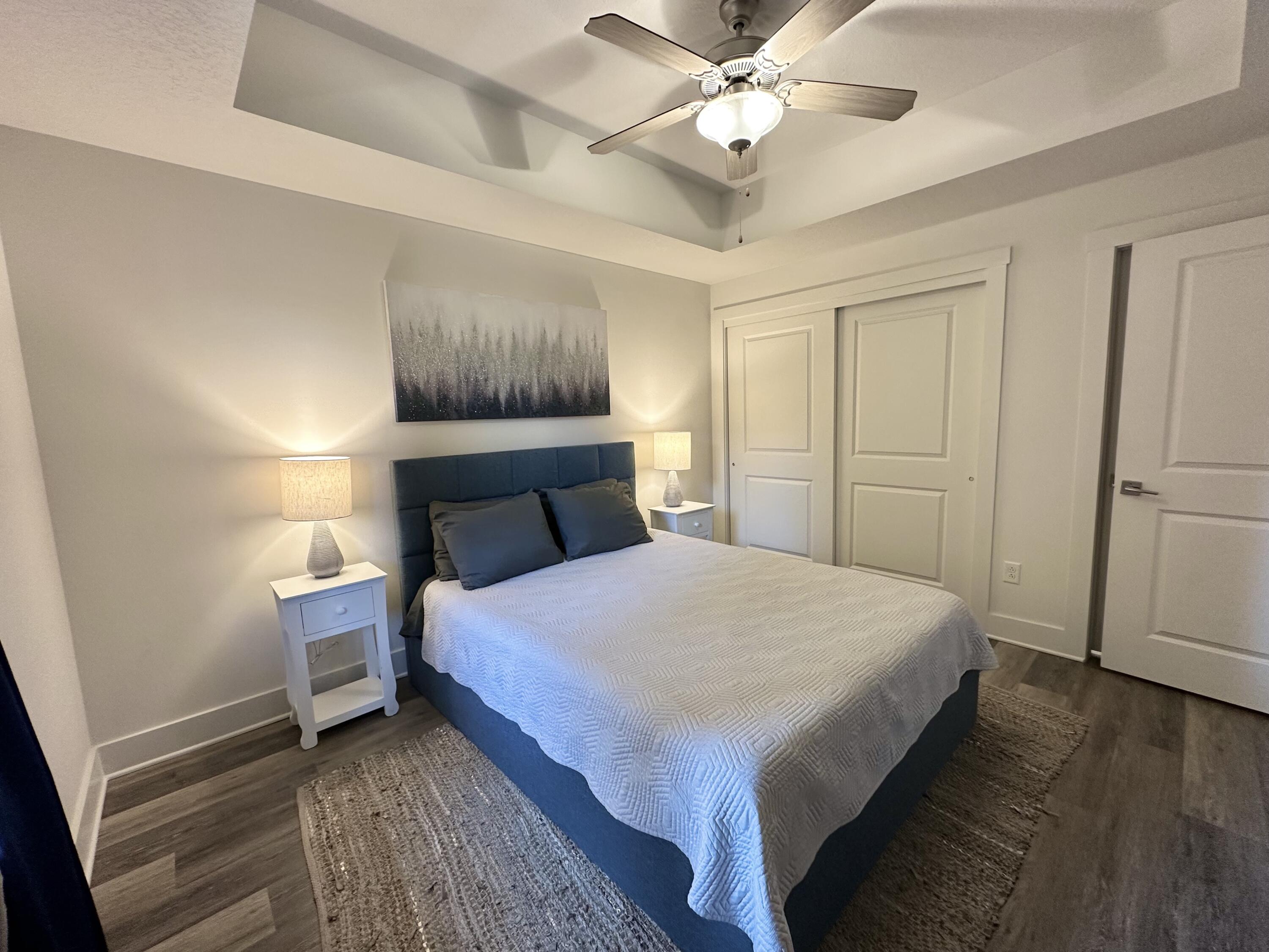 15928 Front Beach Road, Unit 3702 Panama City Beach, FL 32413 - Photo 37 of 85 a bedroom with a bed and a chandelier